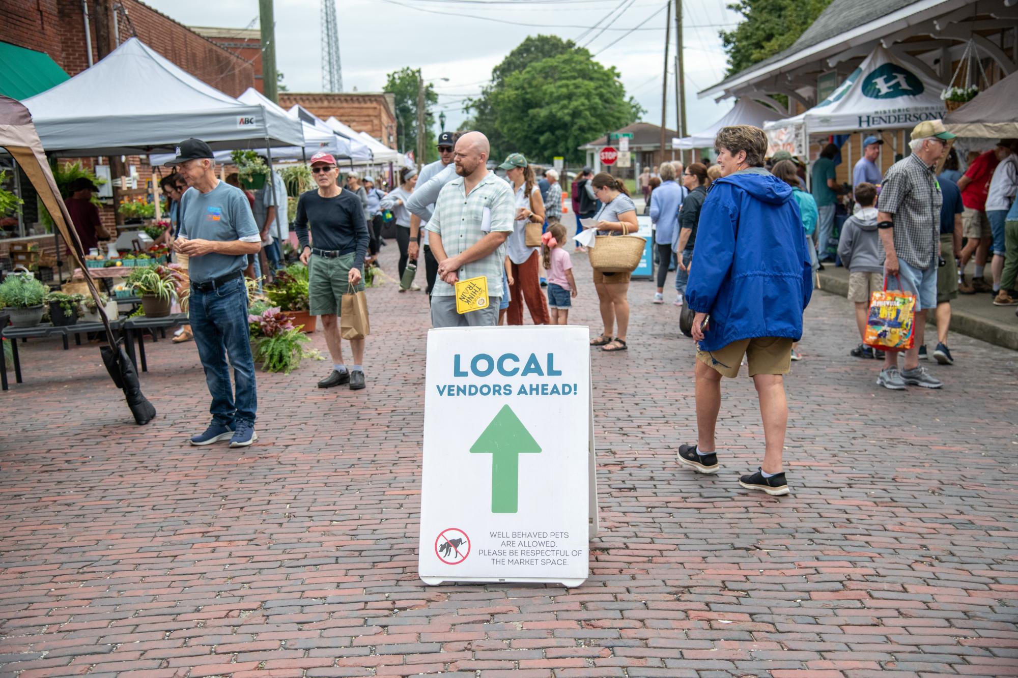 Crowd of people shopping at the Hendersonville Farmers Market