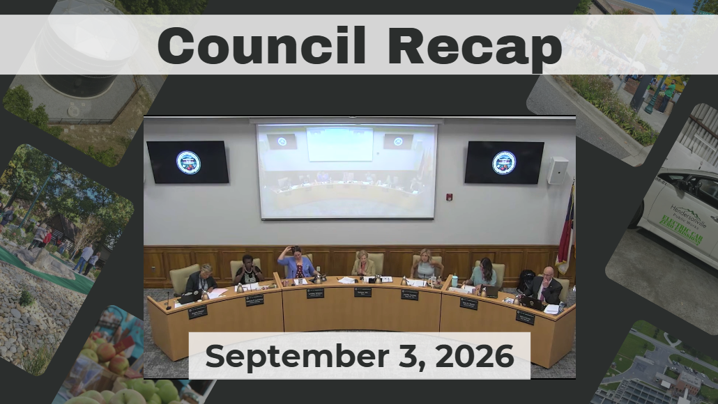 Council members sit around dais. 