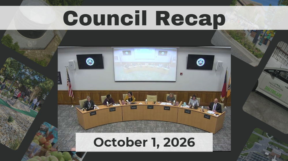 Council members sit around dais.