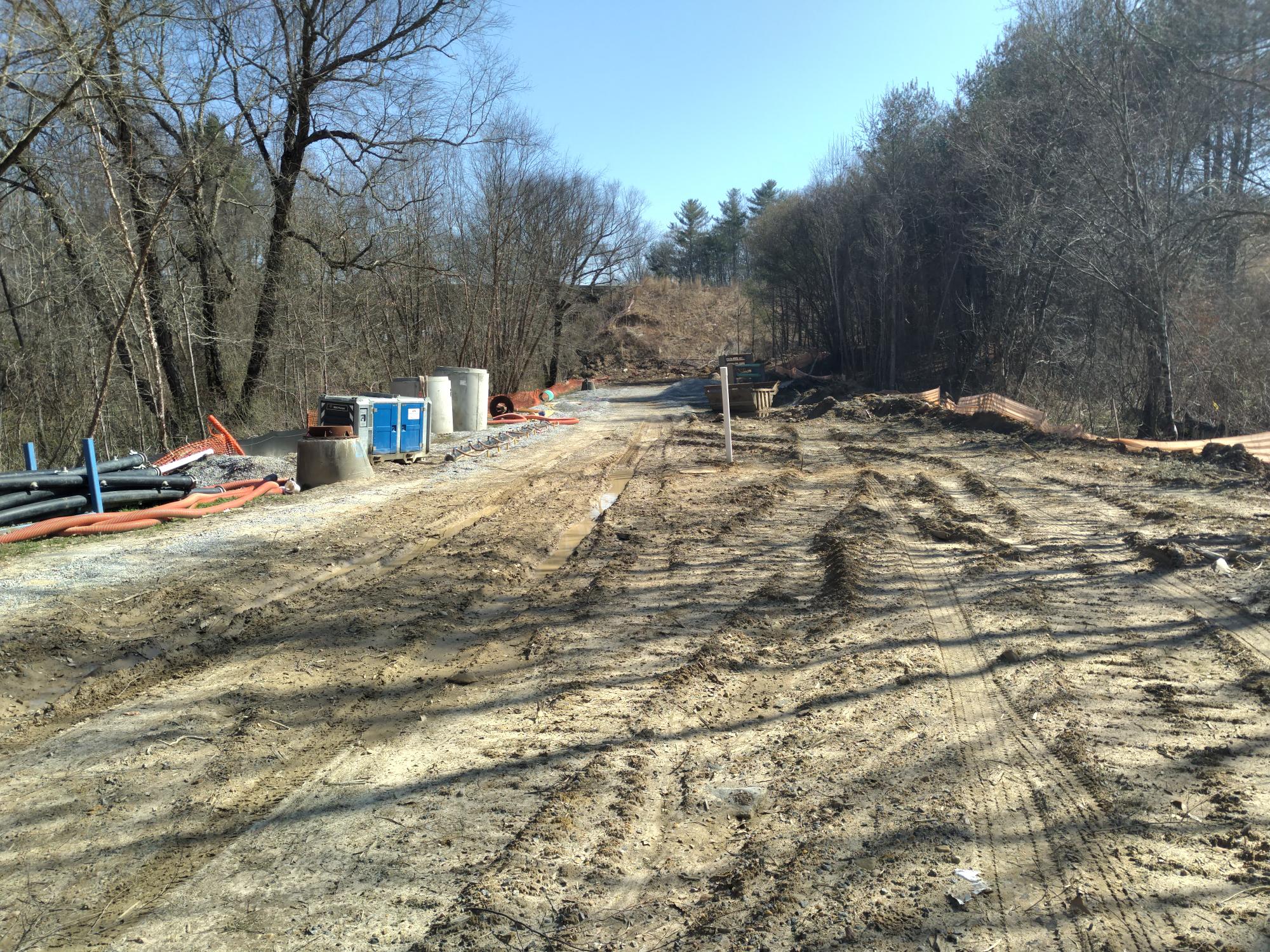 Sewer construction site with manholes and erosion control.